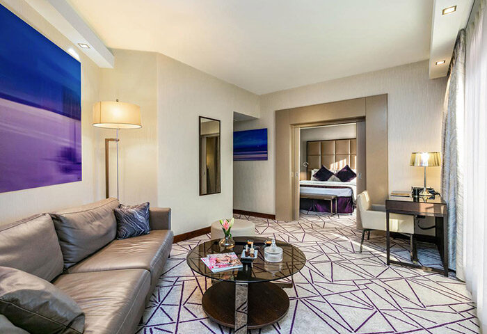 Carlton Tel Aviv Hotel suite living room. Luxury gay hotel with bedroom view. Modern design, perfect for gay travel.