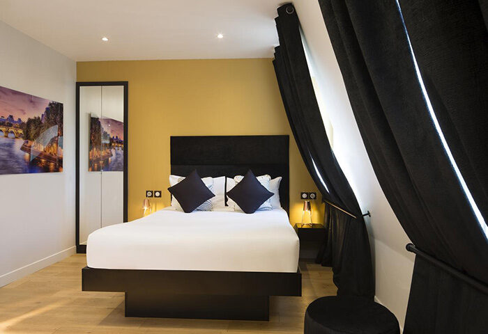 Le Relais du Marais Hotel room, Paris. Close to gay nightlife. Modern design, black & white decor, double bed, stylish curtains. Great location.
