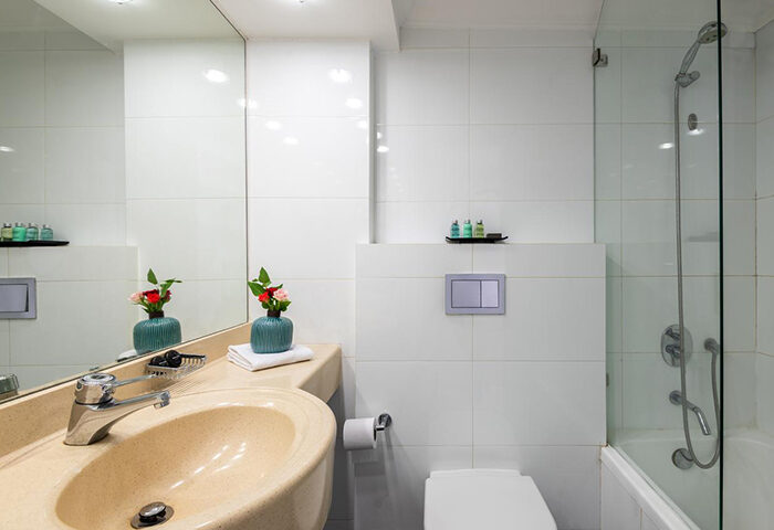 Bathroom at Leonardo Art Tel Aviv by the Beach, a most booked gay hotel near Tel Aviv's gay beach Hilton, featuring modern design.