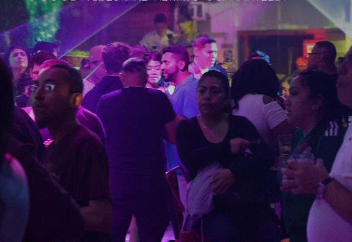 Gay bar scene in New York City. Diverse crowd enjoying nightlife. Les Hommes Gay Cruise and Bar, vibrant atmosphere, travel advice.
