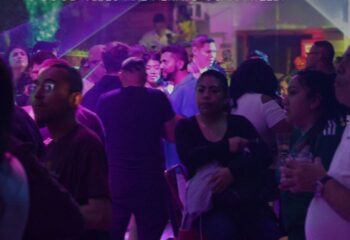 Gay bar scene in New York City. Diverse crowd enjoying nightlife. Les Hommes Gay Cruise and Bar, vibrant atmosphere, travel advice.