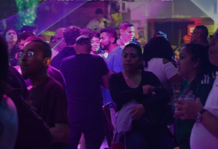 Gay bar scene in New York City. Diverse crowd enjoying nightlife. Les Hommes Gay Cruise and Bar, vibrant atmosphere, travel advice.