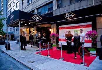 Lips Drag Queen Palace in New York. Red carpet event at the entrance of the drag show venue. Gay travel destination.