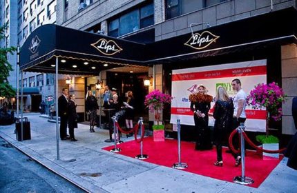 Lips Drag Queen Palace in New York. Red carpet event at the entrance of the drag show venue. Gay travel destination.