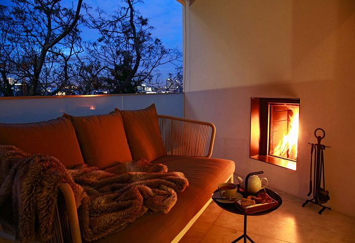 Memmo Principe Real Design Hotel, Lisbon: Balcony view with a fireplace, sofa, and tea set. Popular gay honeymoon hotel in city center.