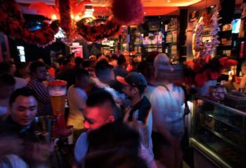 Crowded Lluvia Gay Bar in Singapore's Chinatown. Popular spot with karaoke, drinks, and a lively atmosphere for gay men travelers.