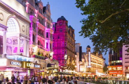 London City Centre street view at night. Gay-friendly Assembly Hotel area with cinemas, casinos, and restaurants. Popular gay travel destination.