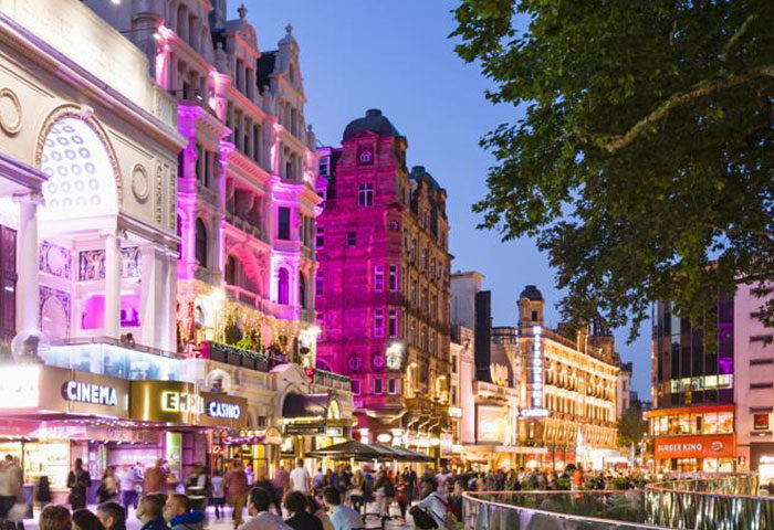 London City Centre street view at night. Gay-friendly Assembly Hotel area with cinemas, casinos, and restaurants. Popular gay travel destination.