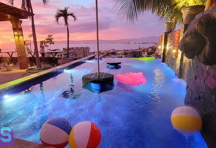The Lookout gay bar in Puerto Vallarta. Infinity pool with beach balls, sunset view. Gay travel destination.