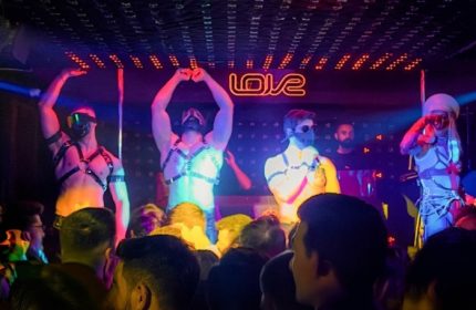 Istanbul gay nightlife: dancers at Love Dance Point club. Men in harnesses perform for a crowd in a vibrant, energetic atmosphere.