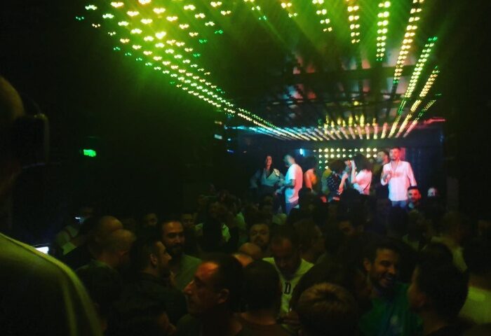 Istanbul gay nightlife: Crowded dance floor at Love Dance Point, a popular gay club. Green lights illuminate the dancing men.