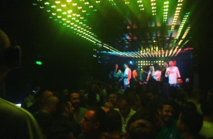 Istanbul gay nightlife: Crowded dance floor at Love Dance Point, a popular gay club. Green lights illuminate the dancing men.