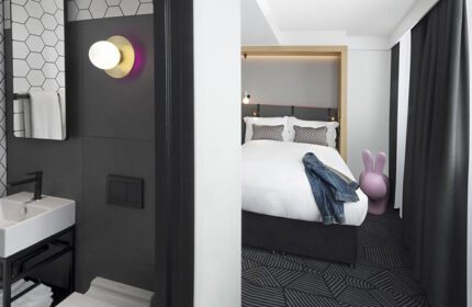 Assembly Hotel, luxury affordable gay-friendly London hotel room. Modern design with bathroom, bed, and playful decor for gay men travelers.