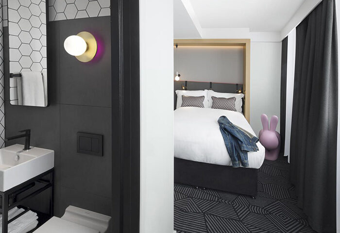 Assembly Hotel, luxury affordable gay-friendly London hotel room. Modern design with bathroom, bed, and playful decor for gay men travelers.