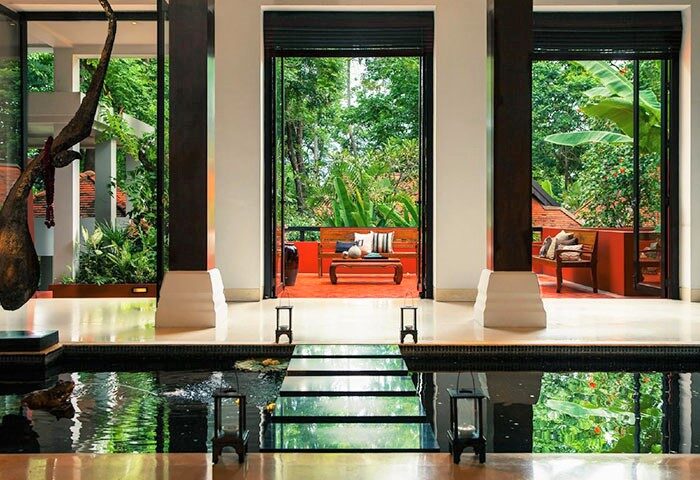 Renaissance Resort & Spa, Koh Samui. Interior view of the luxury beach resort with pond, stepping stones, & lush tropical garden views.