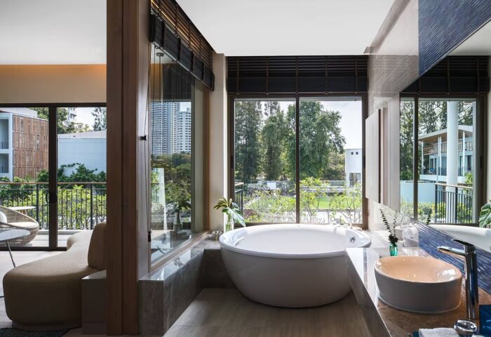 Luxury gay-friendly private pool villa near Bangkok at Renaissance Pattaya Resort & Spa. Upscale bathroom with soaking tub and nature views.