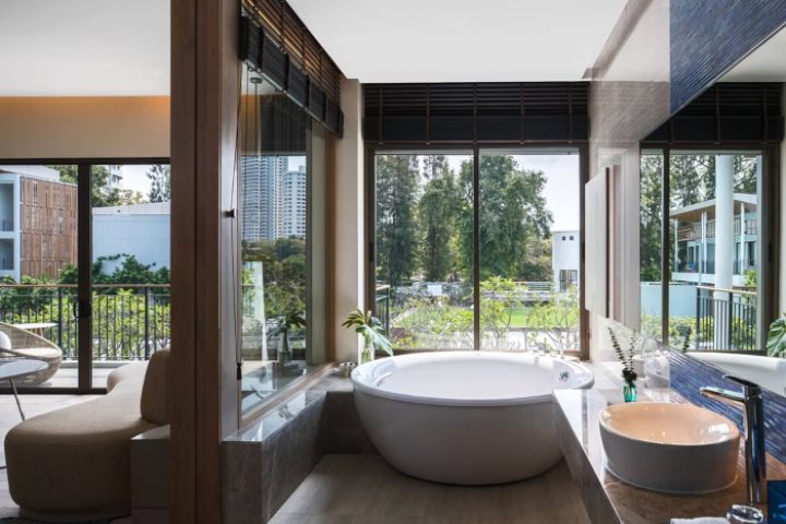 Luxury gay-friendly private pool villa near Bangkok at Renaissance Pattaya Resort & Spa. Upscale bathroom with soaking tub and nature views.