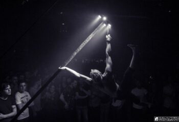 Montreal gay dance party at Le Belmont: Aerialist performs above the crowd. Nightlife for gay men in Montreal, Quebec.