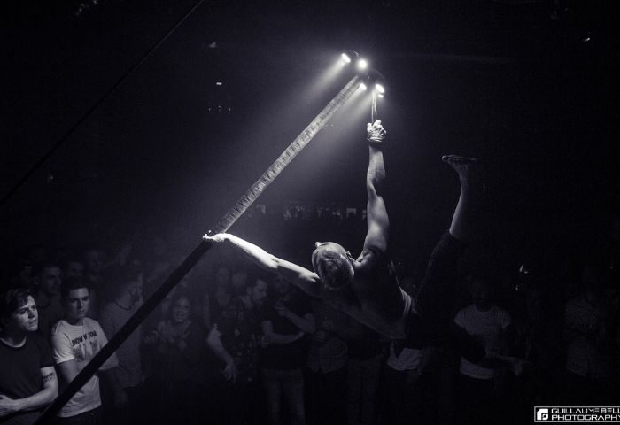 Montreal gay dance party at Le Belmont: Aerialist performs above the crowd. Nightlife for gay men in Montreal, Quebec.