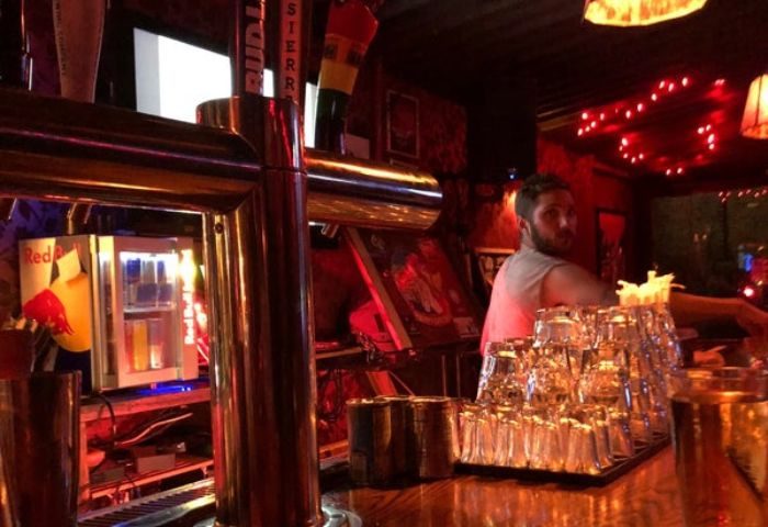 Inside Macri Park gay video bar in New York. Barman, glasses, beer taps, and Red Bull fridge. Gay travel advice, nightlife.