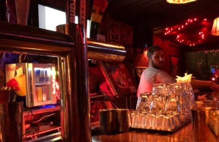 Inside Macri Park gay video bar in New York. Barman, glasses, beer taps, and Red Bull fridge. Gay travel advice, nightlife.