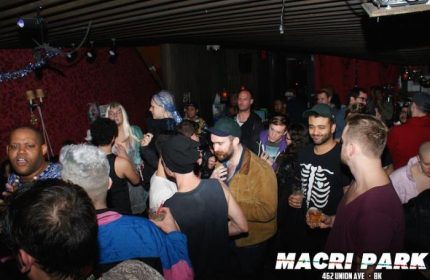 Crowded Macri Park gay video bar in New York. Gay nightlife scene, with men socializing and dancing. Popular gay travel destination.