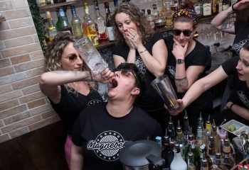 Magnebevo bar staff in Rome's Pigneto district pour a drink directly into a customer's mouth. A fun, gay-friendly travel experience.