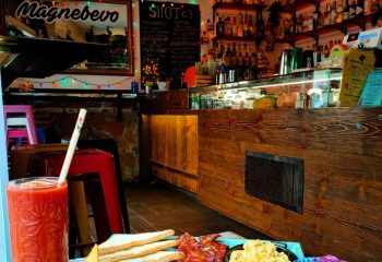 Magnebevo bar in Pigneto, Rome. Breakfast with Bloody Mary, toast, bacon, and scrambled eggs. Gay travel advice for LGBTQ+ visitors.