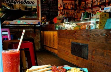 Magnebevo bar in Pigneto, Rome. Breakfast with Bloody Mary, toast, bacon, and scrambled eggs. Gay travel advice for LGBTQ+ visitors.