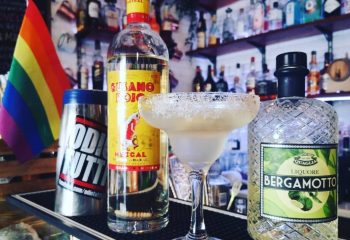 Gay bar in Pigneto, Rome. Cocktail with Gusano Rojo Mezcal, Bergamotto liqueur, rainbow flag. Gay travel advice, LGBTQ+ nightlife in Italy.