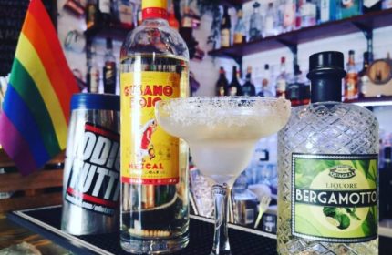 Gay bar in Pigneto, Rome. Cocktail with Gusano Rojo Mezcal, Bergamotto liqueur, rainbow flag. Gay travel advice, LGBTQ+ nightlife in Italy.