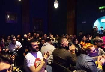 Audience applauding at Malo Glitter Bar in Rome. Gay men travel advice: a vibrant, inclusive space for entertainment and community.