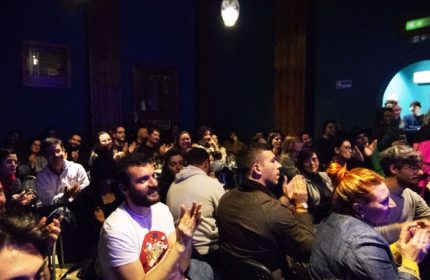 Audience applauding at Malo Glitter Bar in Rome. Gay men travel advice: a vibrant, inclusive space for entertainment and community.