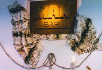 Man Bar sign in Sitges, a gay bar destination. The sign is decorated with faux fur and rope, creating a unique, rustic aesthetic.