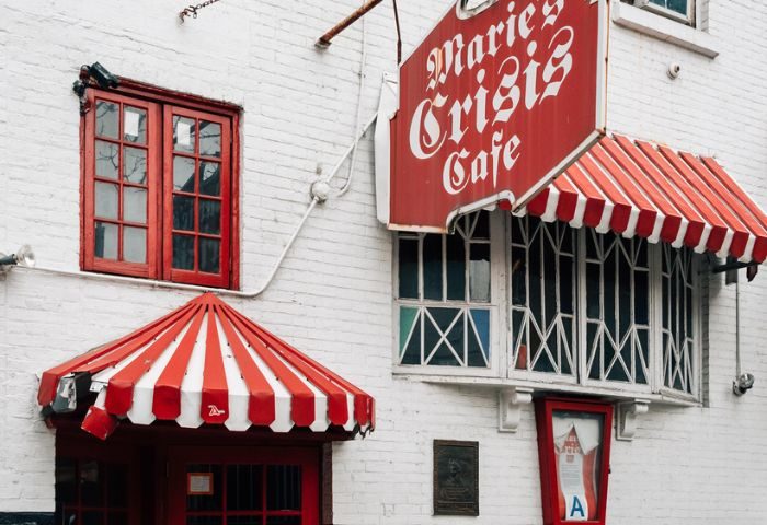 Marie's Crisis Cafe, a gay-friendly sing-a-long bar in New York City's West Village. Red and white awning, white brick building.