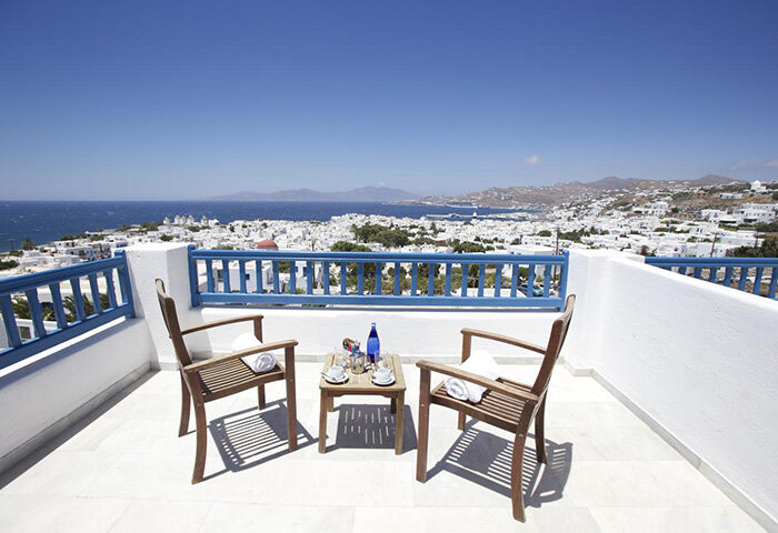 Marisso Hotel Mykonos Town view. Most booked hotel near gay nightlife. Balcony with chairs overlooking the Aegean Sea. Gayborhood travel.