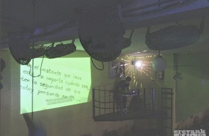 Marrakech Salon Gay Bar in Mexico: DJ on a platform under disco balls. Green wall projection. Gay travel nightlife scene.