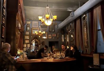 Marty's Martini Bar, Chicago: Gay bar interior featuring patrons, drinks, and ornate decor. A popular spot for gay parties and cocktails.