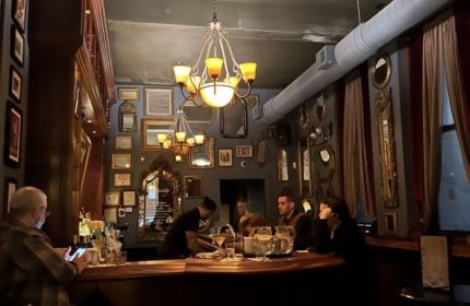 Marty's Martini Bar, Chicago: Gay bar interior featuring patrons, drinks, and ornate decor. A popular spot for gay parties and cocktails.