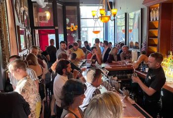 Marty's Martini Bar, a popular gay bar in Chicago. Bartender makes drinks for a busy crowd. Gay party and travel destination.
