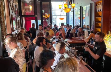 Marty's Martini Bar, a popular gay bar in Chicago. Bartender makes drinks for a busy crowd. Gay party and travel destination.