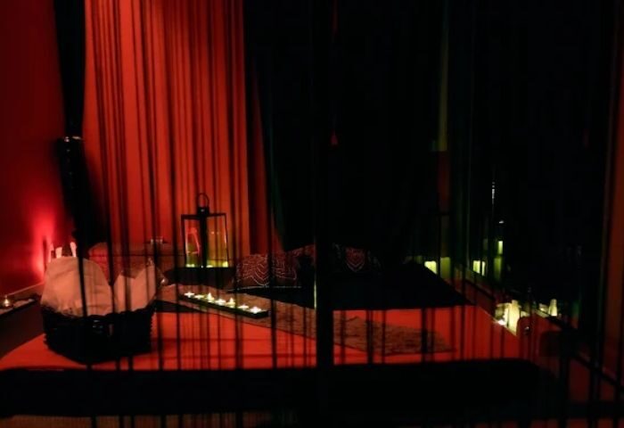 Madrid gay massage: Erotic room with red light, candles, and bed. Majestic massage for gay men's travel advice.