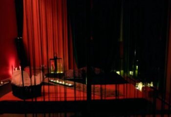 Madrid gay massage: Erotic room with red light, candles, and bed. Majestic massage for gay men's travel advice.