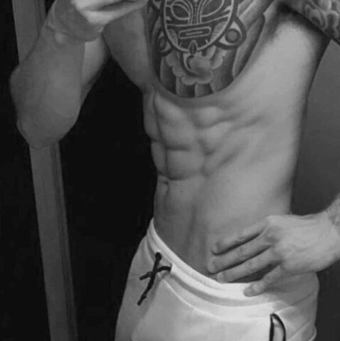 Massage By Bret: Torso of muscular man with abs and tattoo. Gay massage spa promotional image. Black and white.