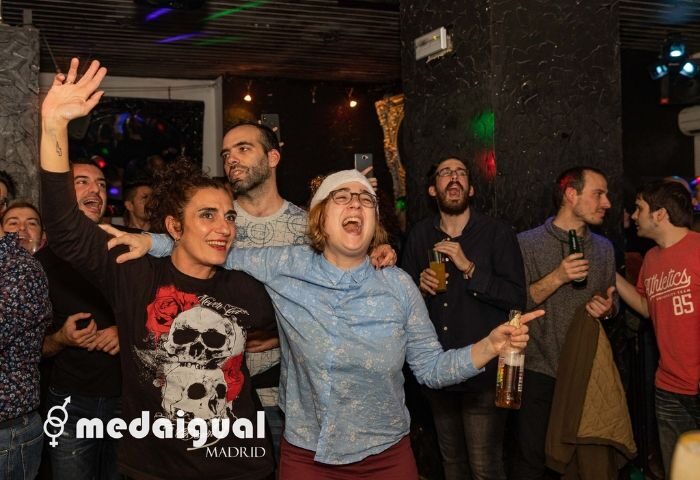 Medaigual Gay Bar in Madrid's Chueca district. People are laughing and enjoying drinks. Gay travel in Madrid, Spain.