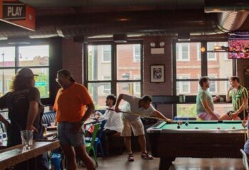Meeting House Tavern, a unique gay bar in Chicago. Men play pool in a relaxed, friendly atmosphere. A great spot for gay travel in Chicago.