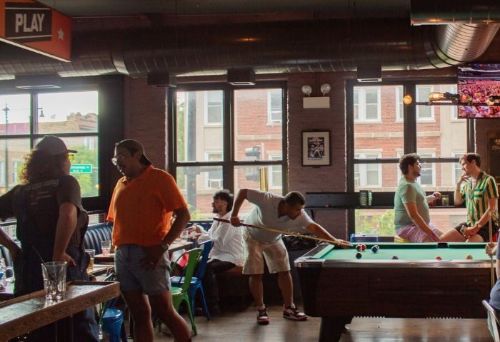 Meeting House Tavern, a unique gay bar in Chicago. Men play pool in a relaxed, friendly atmosphere. A great spot for gay travel in Chicago.