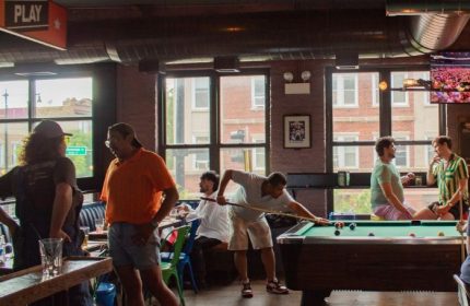 Meeting House Tavern, a unique gay bar in Chicago. Men play pool in a relaxed, friendly atmosphere. A great spot for gay travel in Chicago.