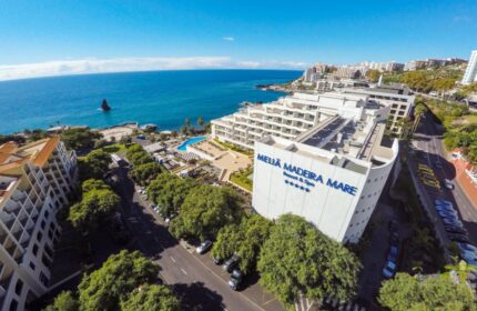 Meliá Madeira Mare gay-friendly hotel aerial view. Coastal resort with pool, spa, and ocean views in Madeira. Gay travel advice.