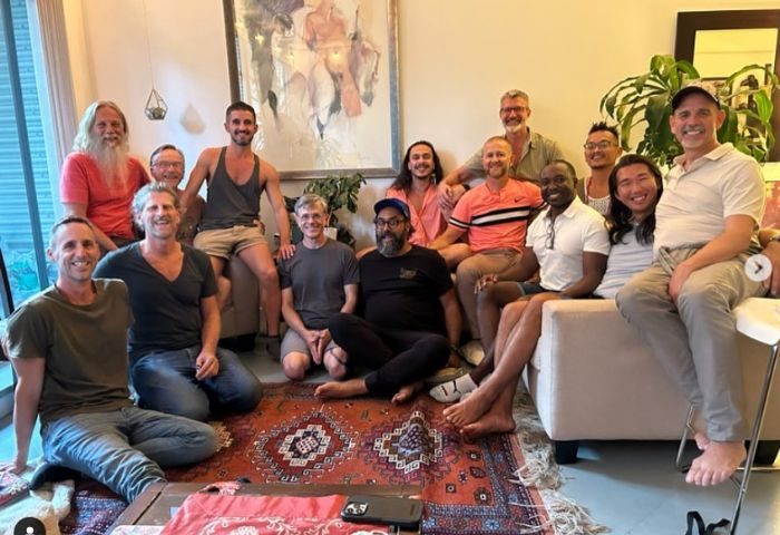 Group of gay men, Trevor James' clients, smiling after a bodywork session. Satisfaction with men's bodywork by Trevor James.
